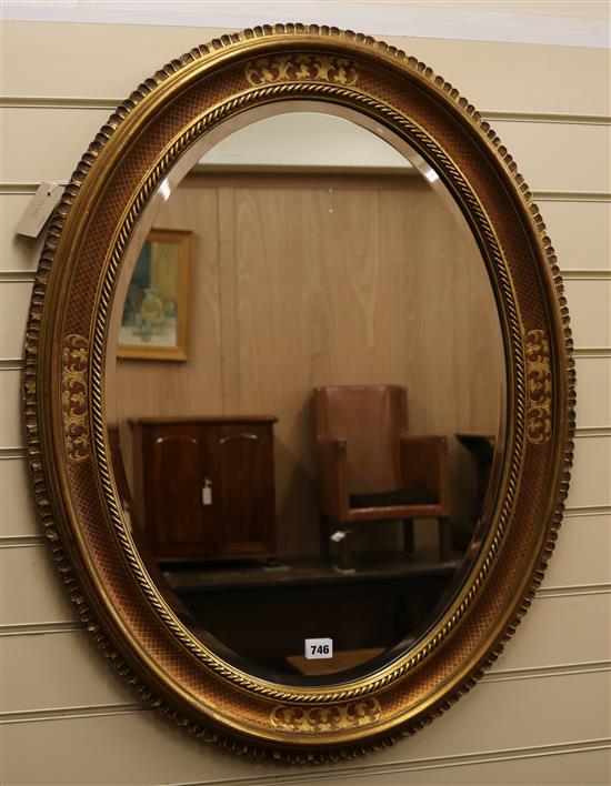 An oval gilt frame wall mirror W.68cm